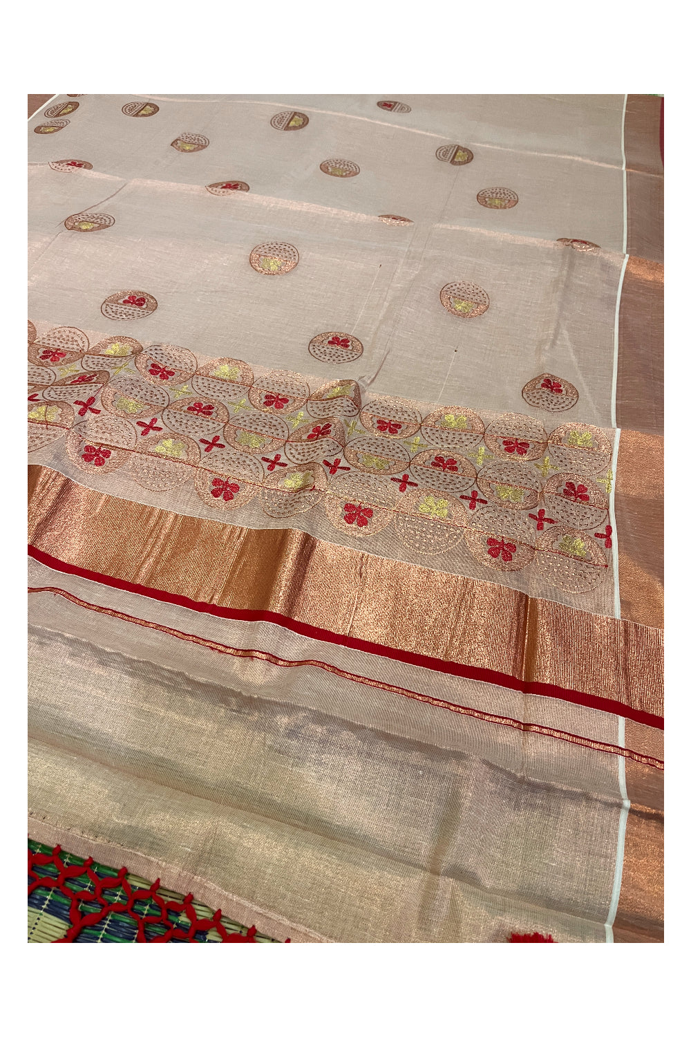 Southloom Copper Tissue Kasavu Saree with Embroidery Design and Red Tassels Works on Pallu
