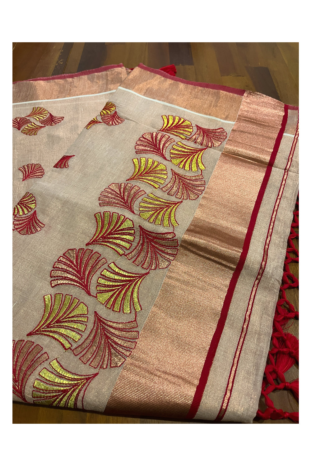 Southloom Copper Tissue Kasavu Saree with Embroidery Design and Red Tassels Works on Pallu