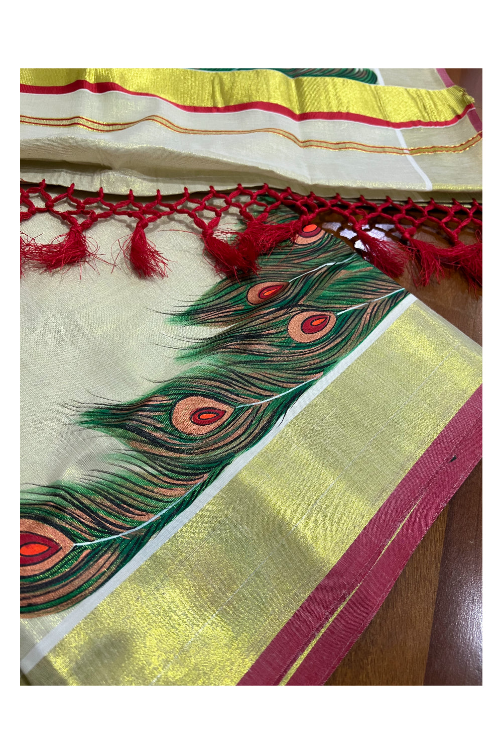 Kerala Tissue Kasavu Saree with Hand Painted Feather Design and Red Tassels Work