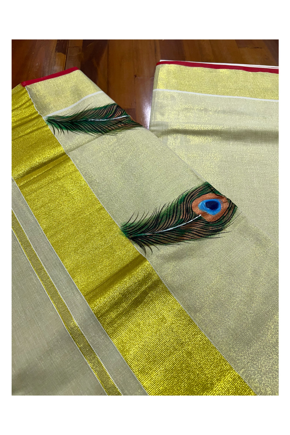 Kerala Tissue Kasavu Saree with Hand Painted Feather Design and Red Line on Border